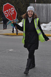 Sue Murphy at crosswalk holding stop sign