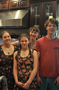 Anna Durand with Phoebe, Faye, and Eli in the kitchen of Acacia House Inn